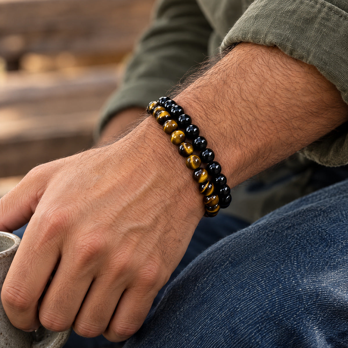 Man wearing an 8mm tiger's eye bracelet stacked with an 8mm black obsidian bracelet