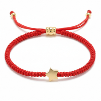 A red braided cord bracelet featuring a prominent gold-colored star charm and adjustable gold-toned beads on a clean white background
