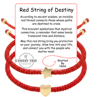 Product photography by Cherry Tree Collection featuring two hand-knotted red string bracelets with gold star and heart charms displayed next to a white information card detailing the Red String of Destiny symbolism