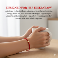 Photograph of a woman's hands holding a white mug on a wooden table, wearing a red string bracelet with a golden star charm, alongside text marketing 'Designed for her inner glow' and enhancing 'feminine energy'