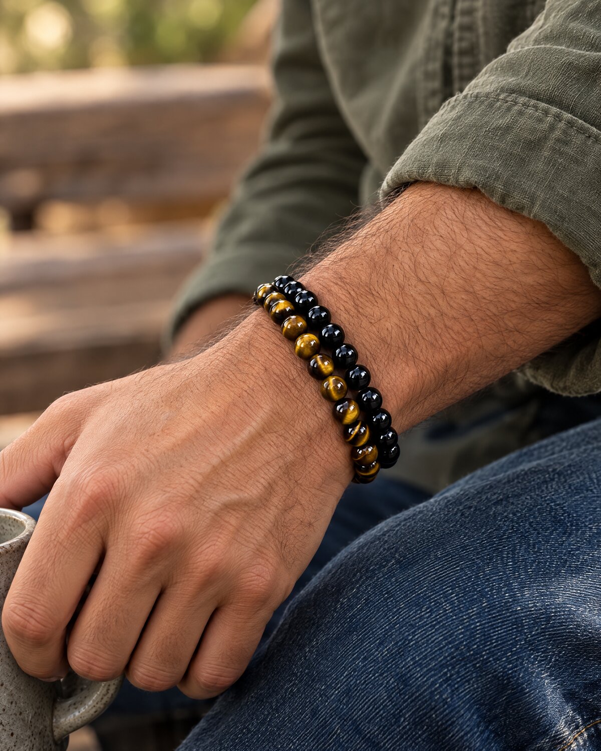 Man wearing an 8mm tiger's eye bracelet stacked with an 8mm black obsidian bracelet